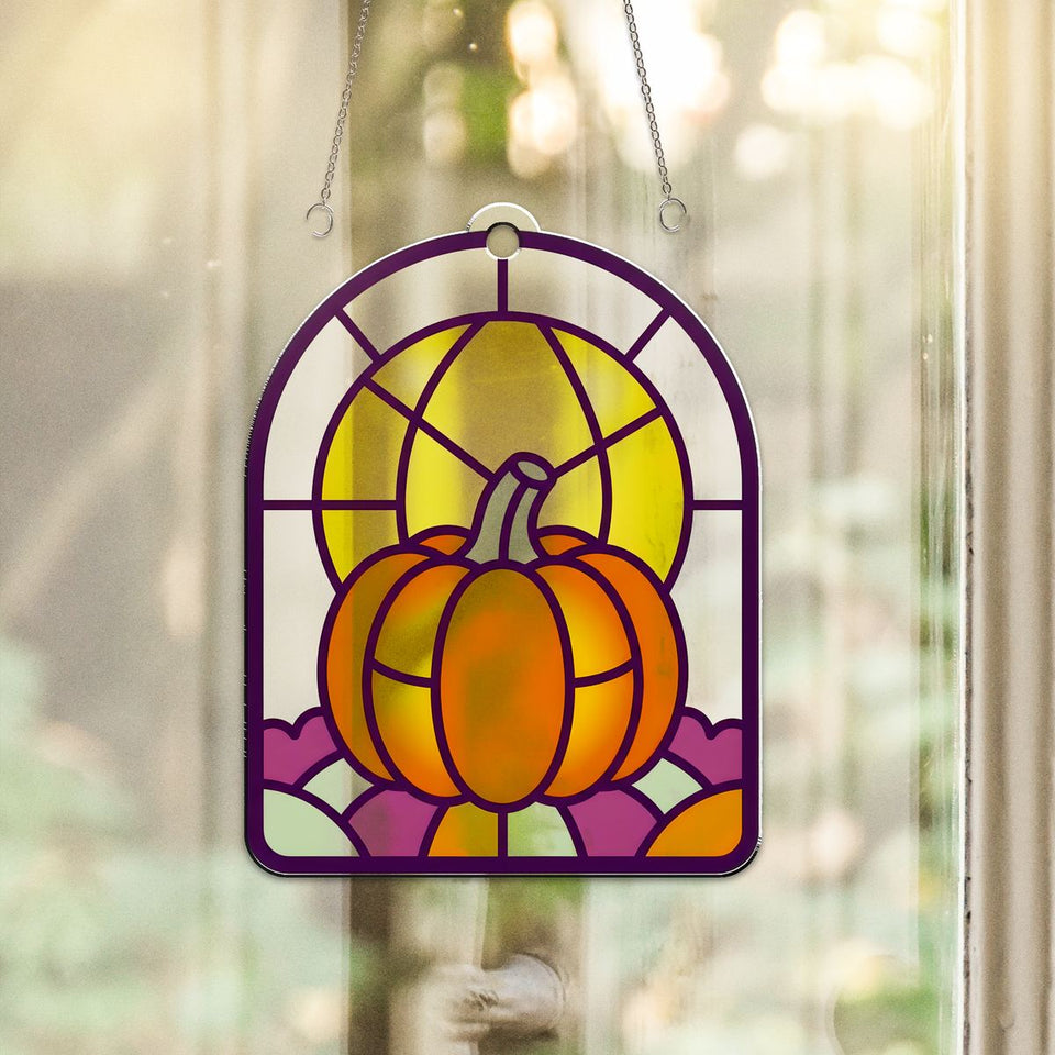 Harvest Moon Pumpkin Arch Acrylic Suncatcher hanging in a sunny window