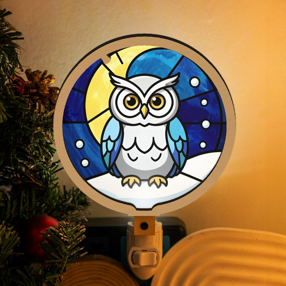 Snowy Owl Winter Moon Plug-In Night Light hanging in a sunny window