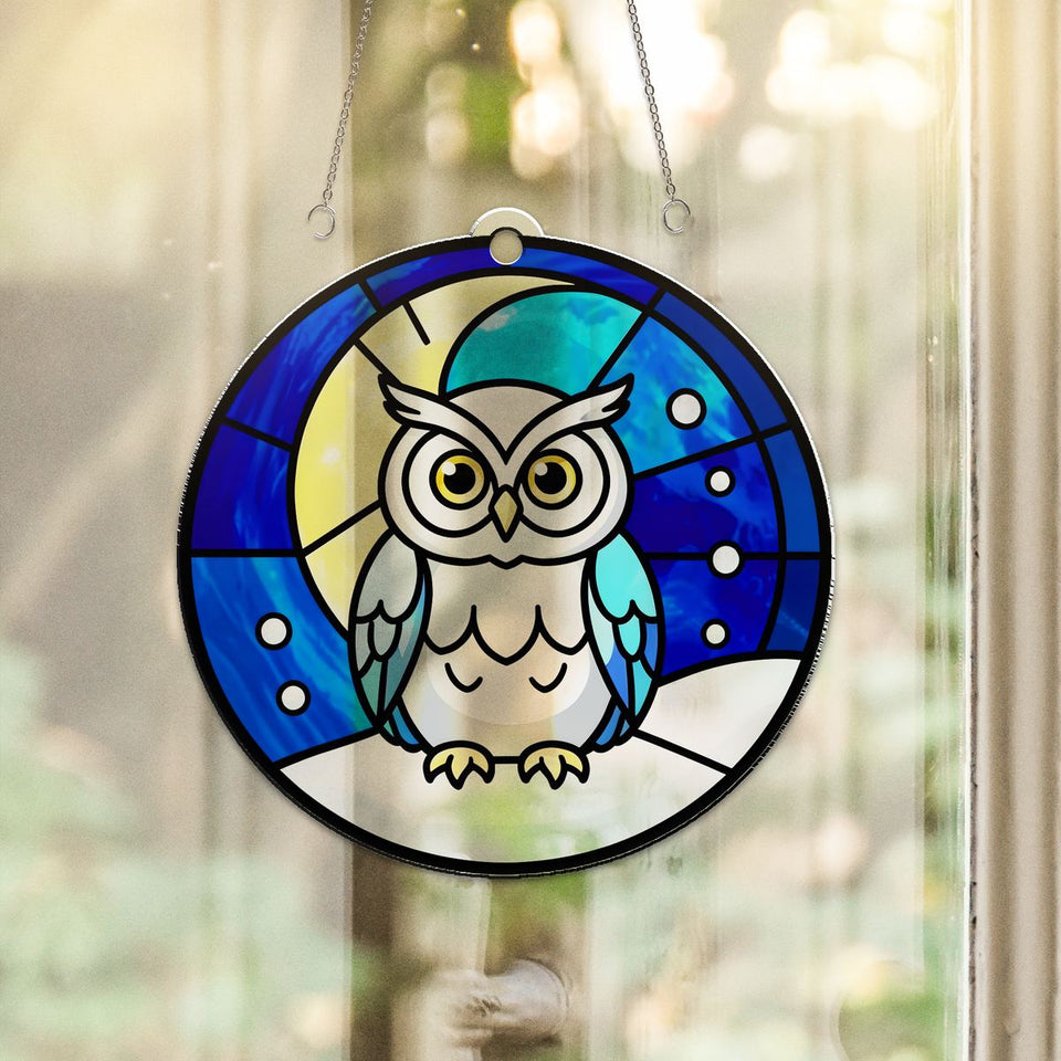 Snowy Owl Winter Moon Acrylic Suncatcher hanging in a sunny window